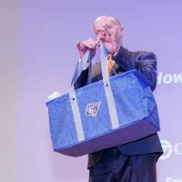 Dr. Jeffrey Potteiger presenting the People's Choice Winner swag bag.